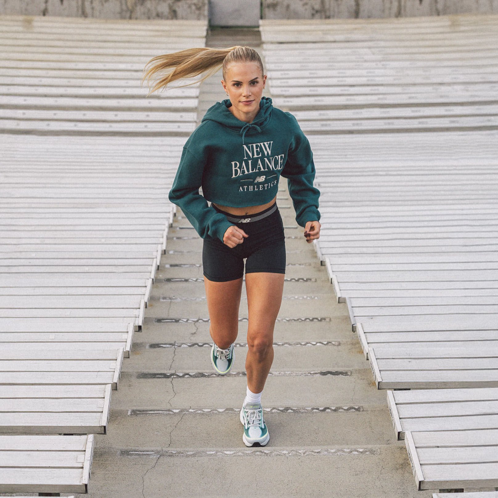 Parker Valby running up bleacher stairs 